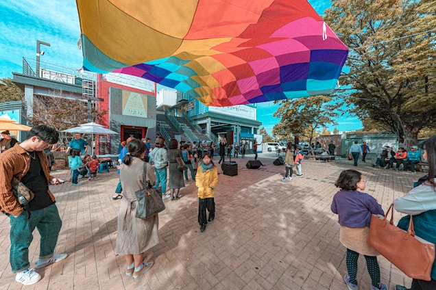 A vibrant community gathering space with people engaging in various activities.