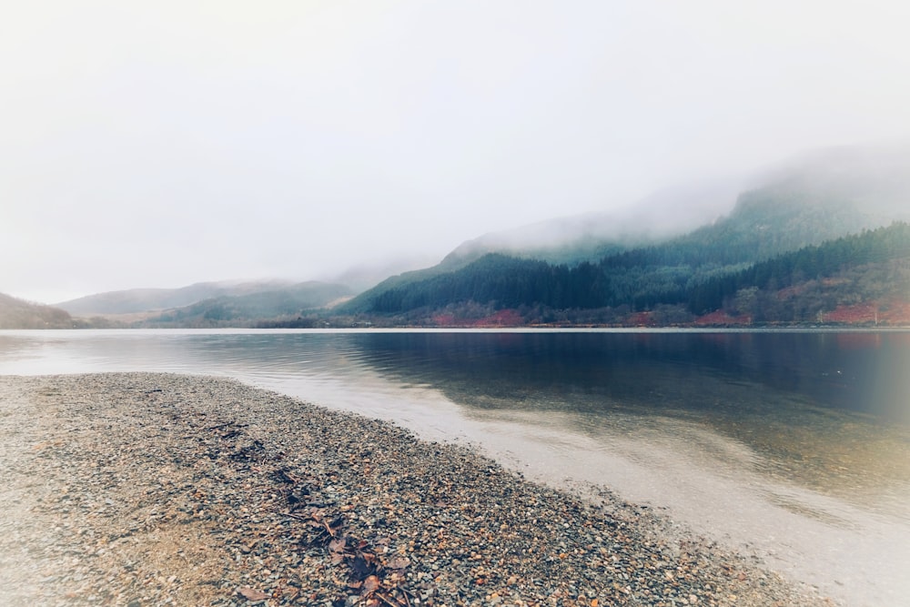 body of water and mountains during day