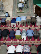 people kneeling on red carpet in church