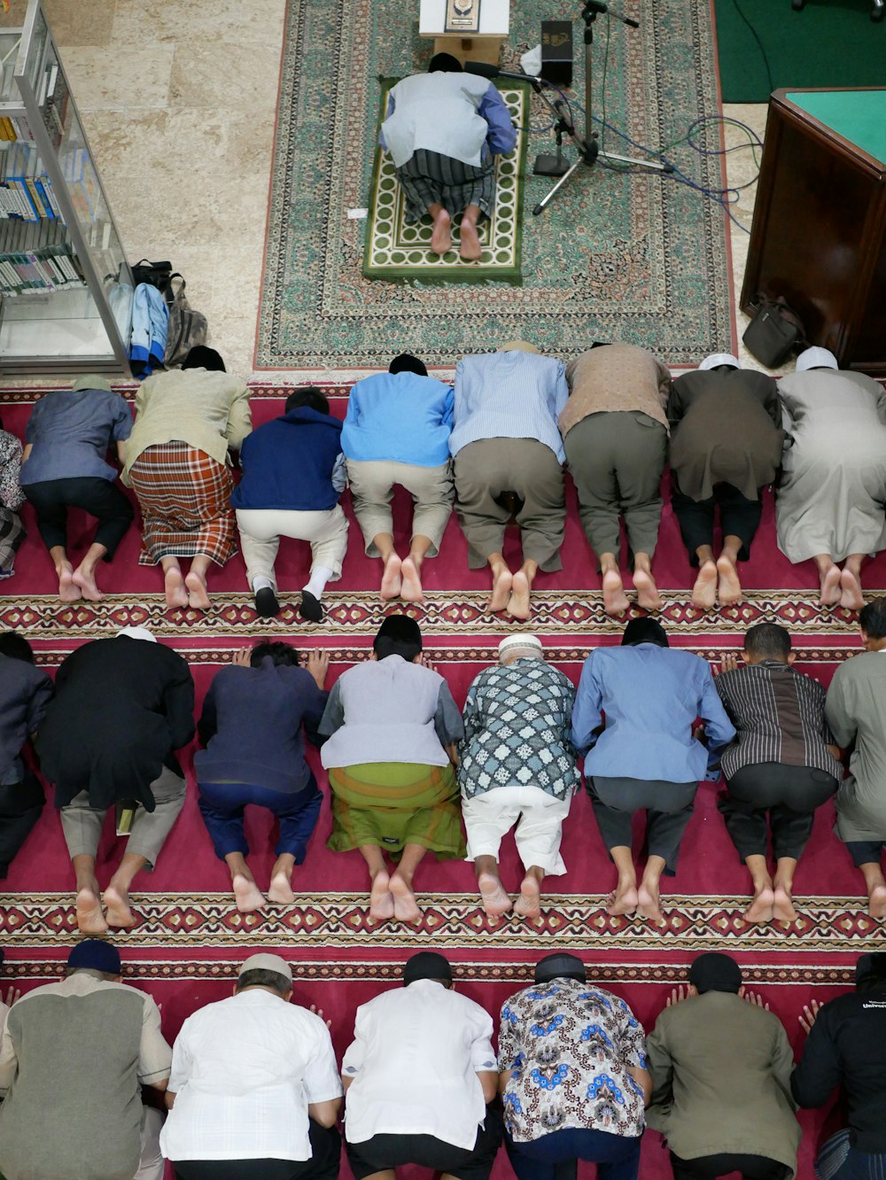 people kneeling on red carpet in church