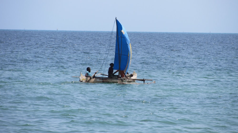 two people in boat on blue body of water during daytime