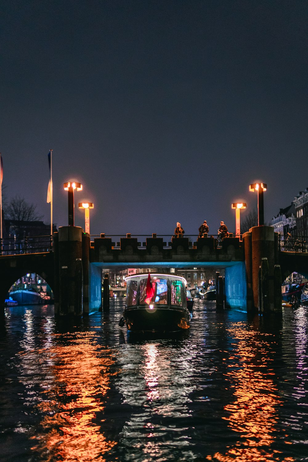 white and black speedboat near the bridge