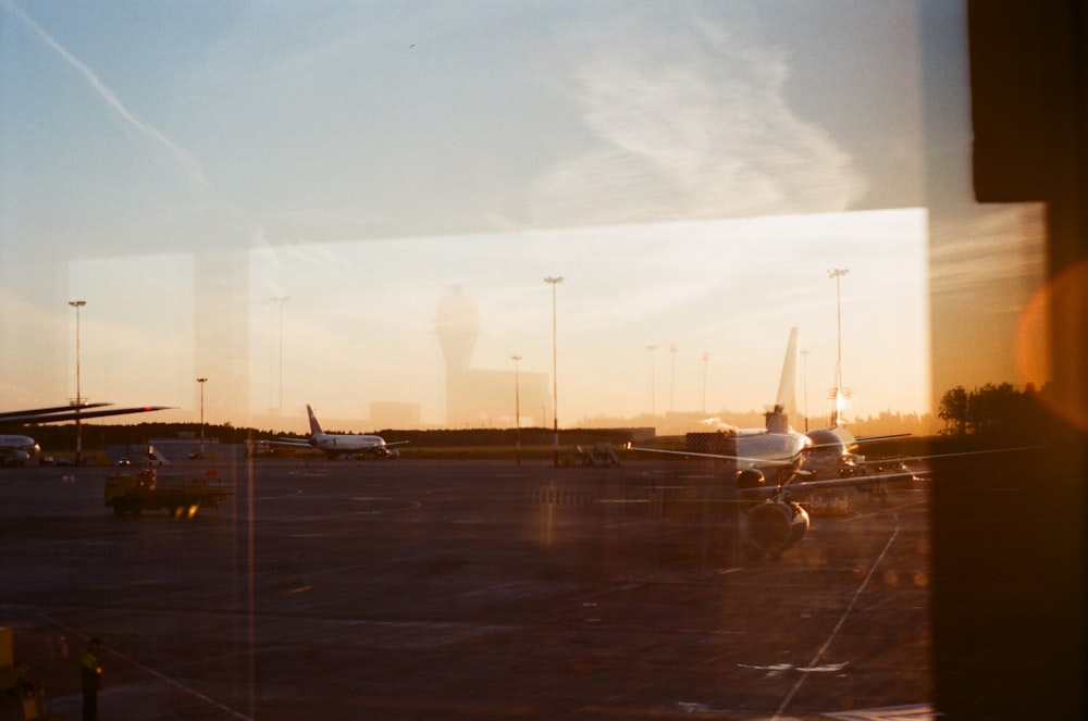 airplanes on airfield during golden hour