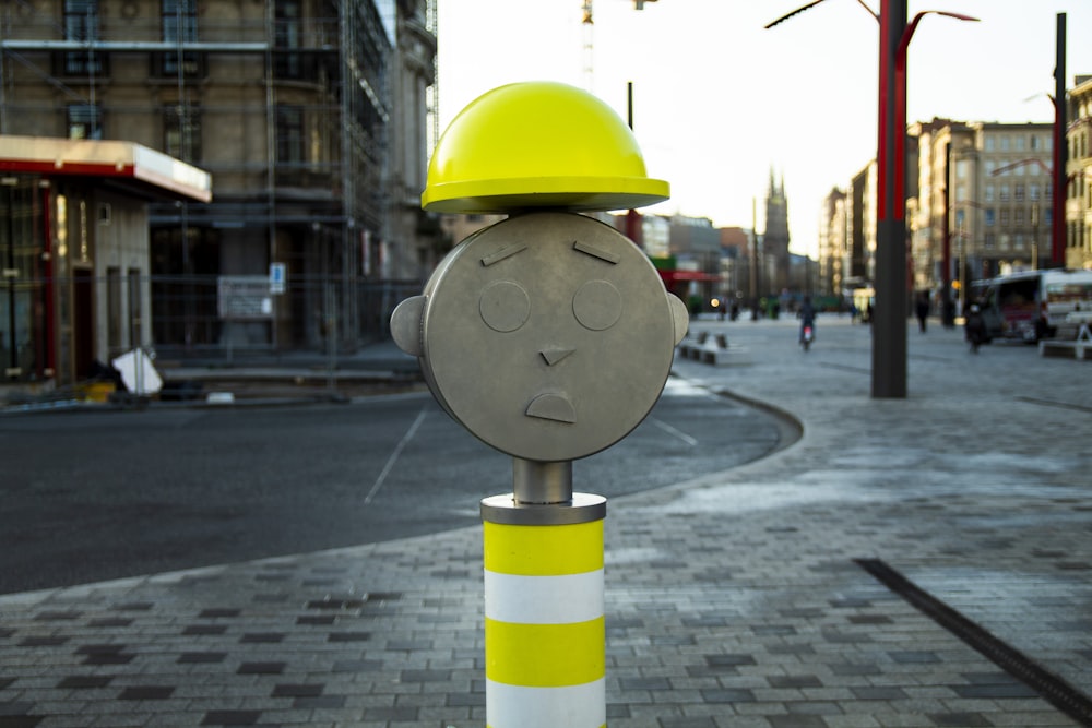brown and yellow construction worker-themed post at the city during day