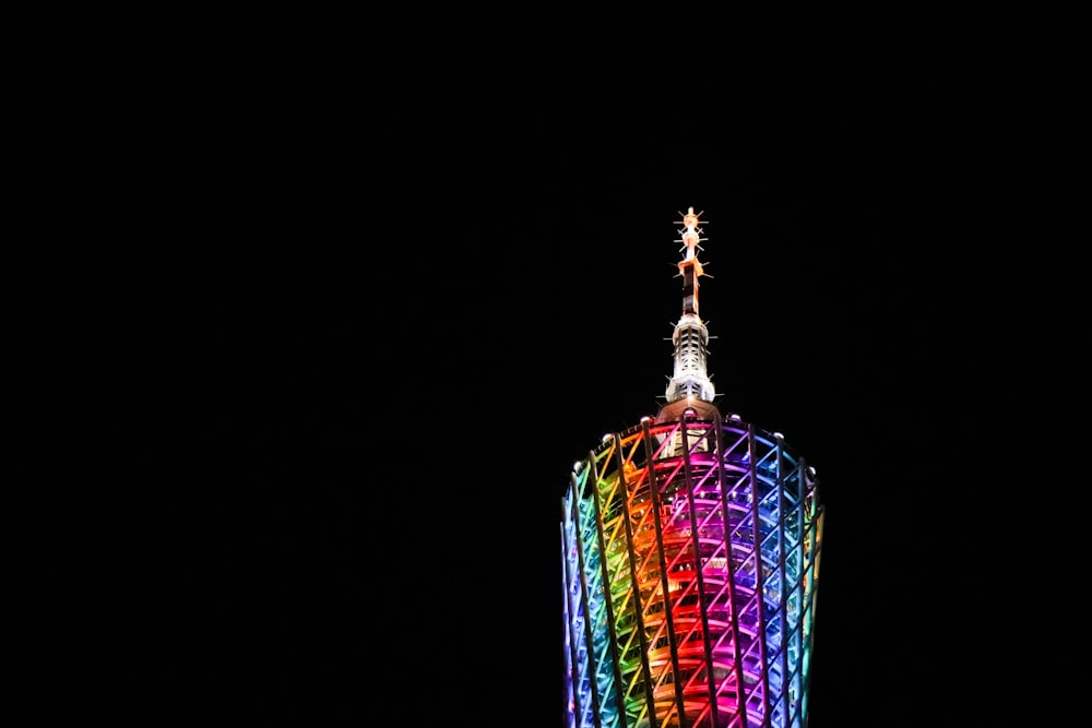 low-angle photography of multicolored tower building during night time