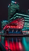 A futuristic cityscape illuminated at night with glowing lights.