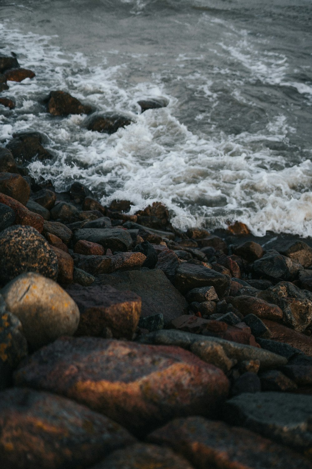 brown and gray rock formations near body of water