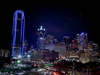 aerial photography of city with high-rise buildings during night time