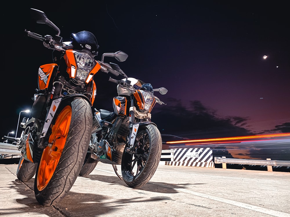 two orange naked motorcycles