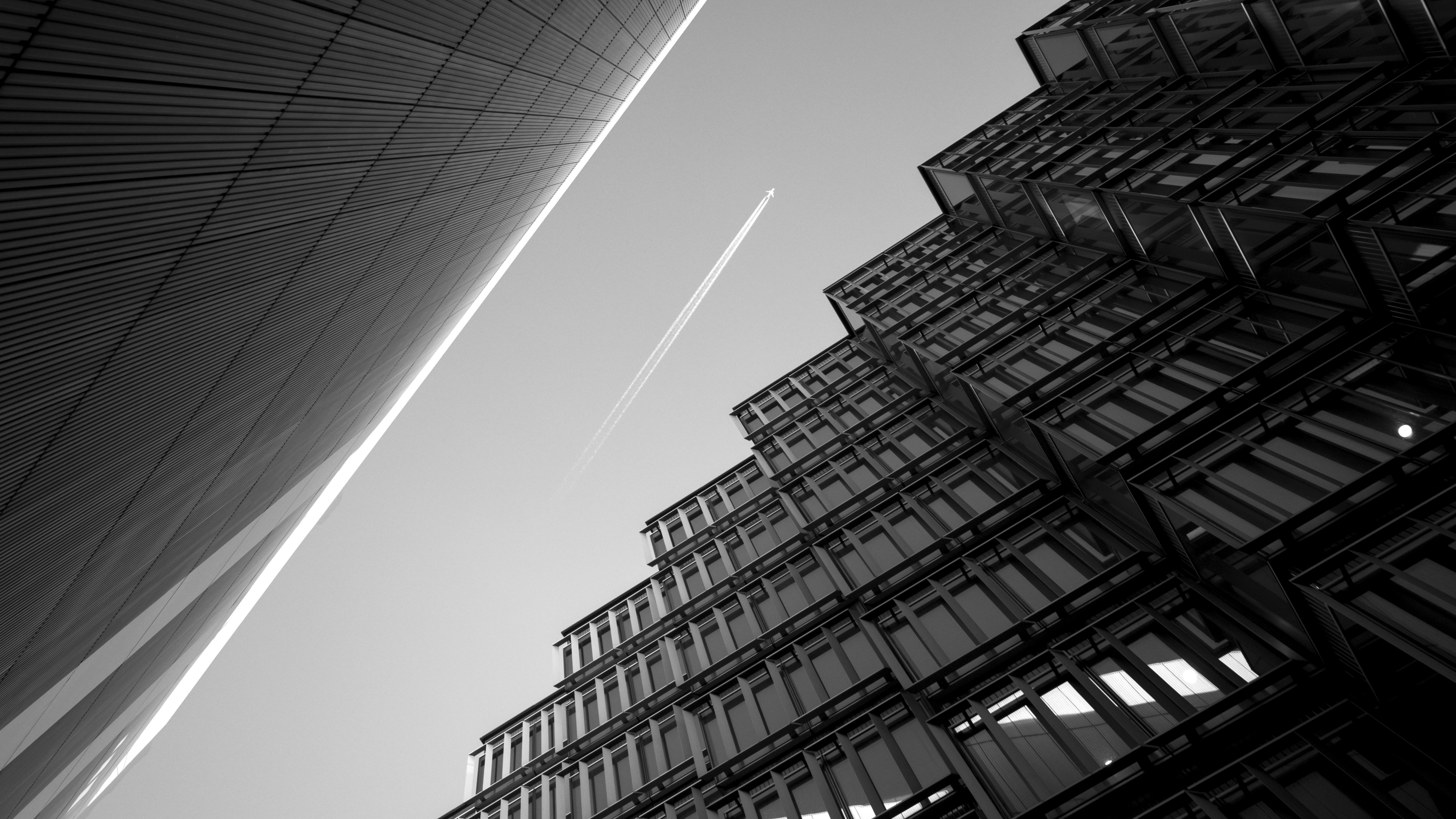 contrails above buildings during day