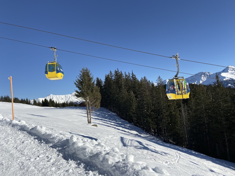 yellow cable car over snow during daytime