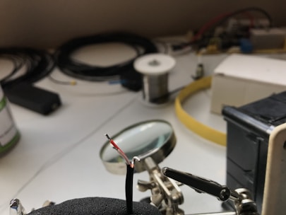 Close-up of a precision soldering iron heating up on a workbench.
