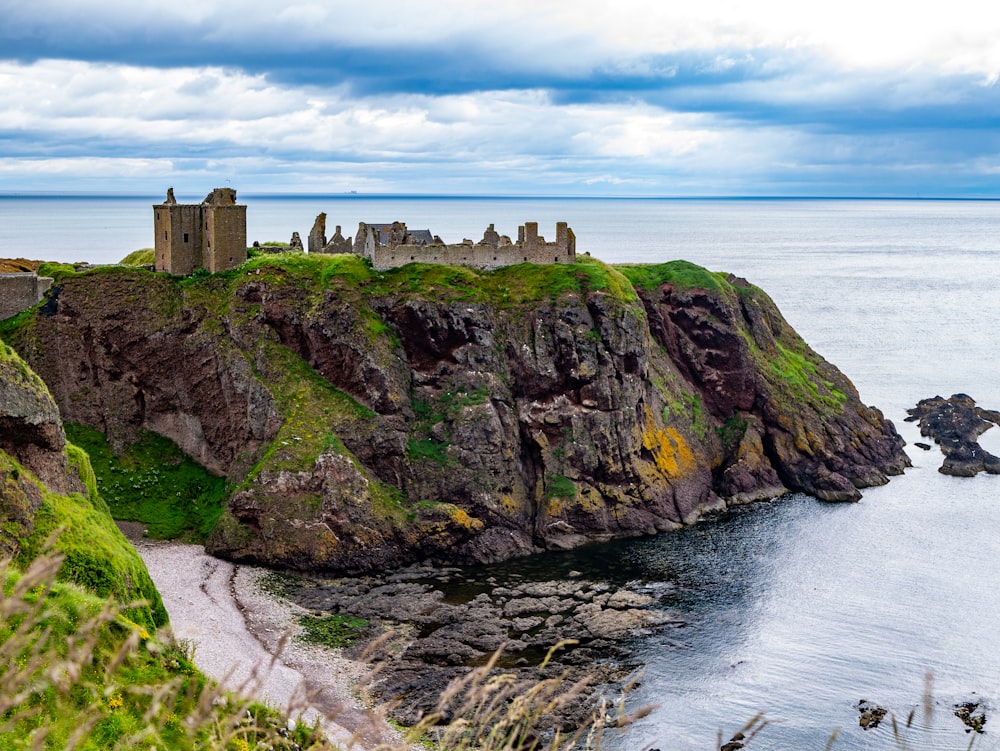 brown castle on top of hill near shore