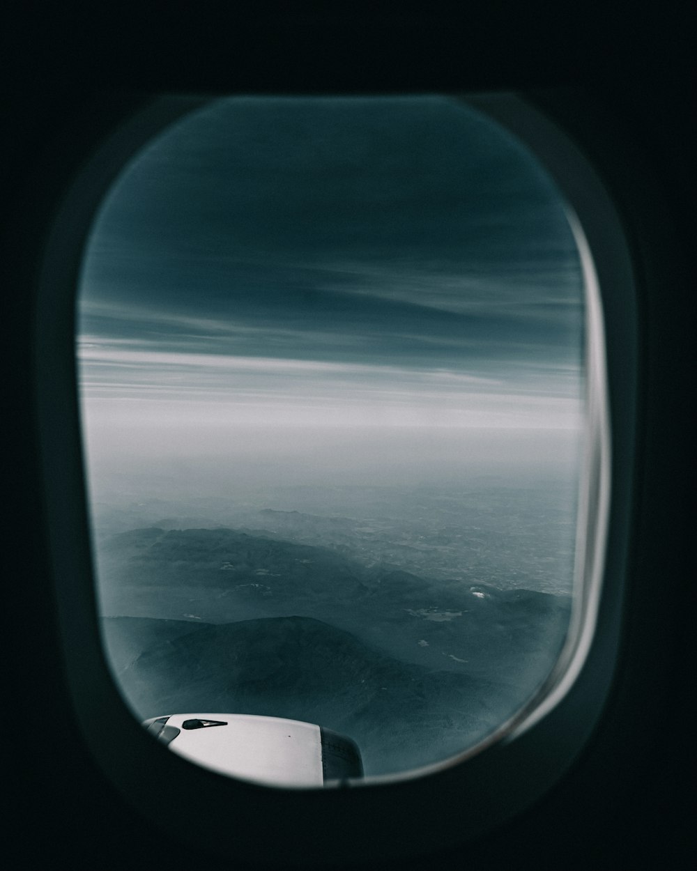 an airplane window with a view of the sky