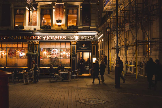 A cozy evening scene outside the Churchill Tap Pub with warm lights glowing and friends gathered at the entrance.