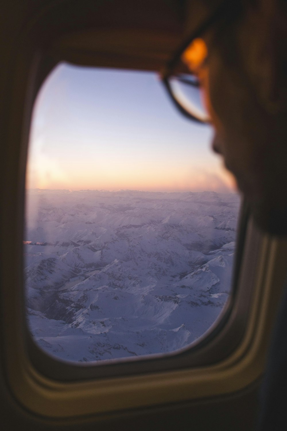 man leaning on plane window