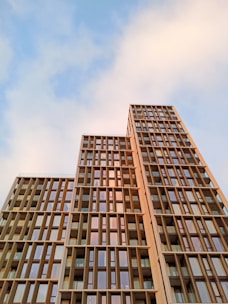 Close-up architectural detail of a high-rise with sharp lines and reflective glass panels under soft evening light.