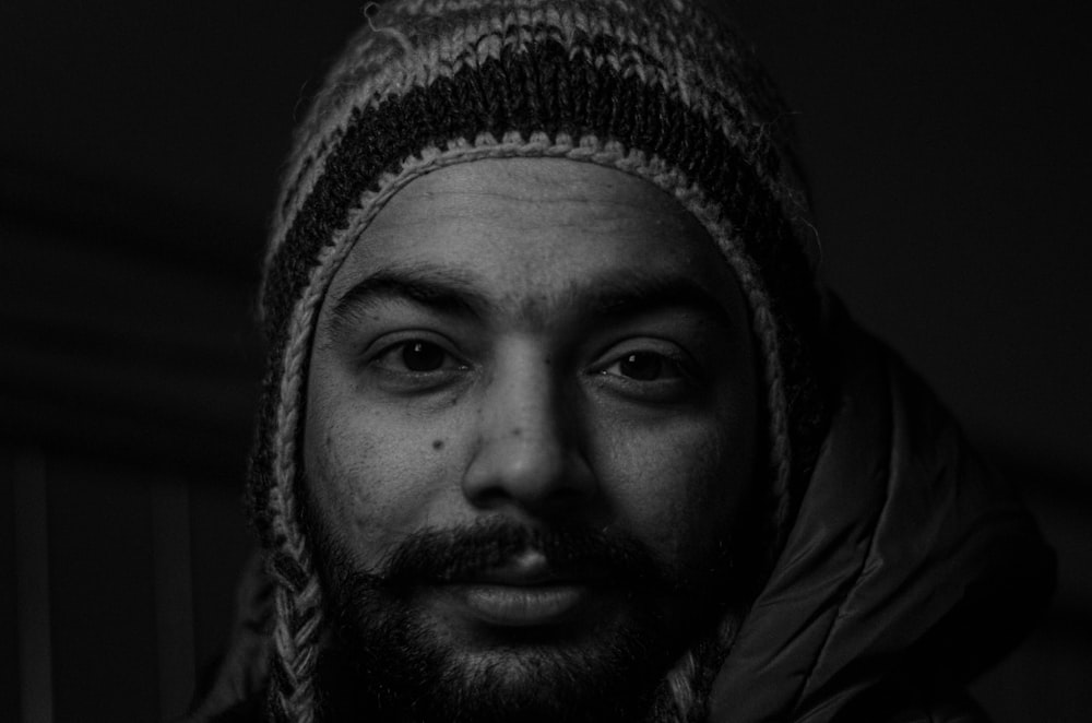 grayscale photography of man wearing knitted beanie