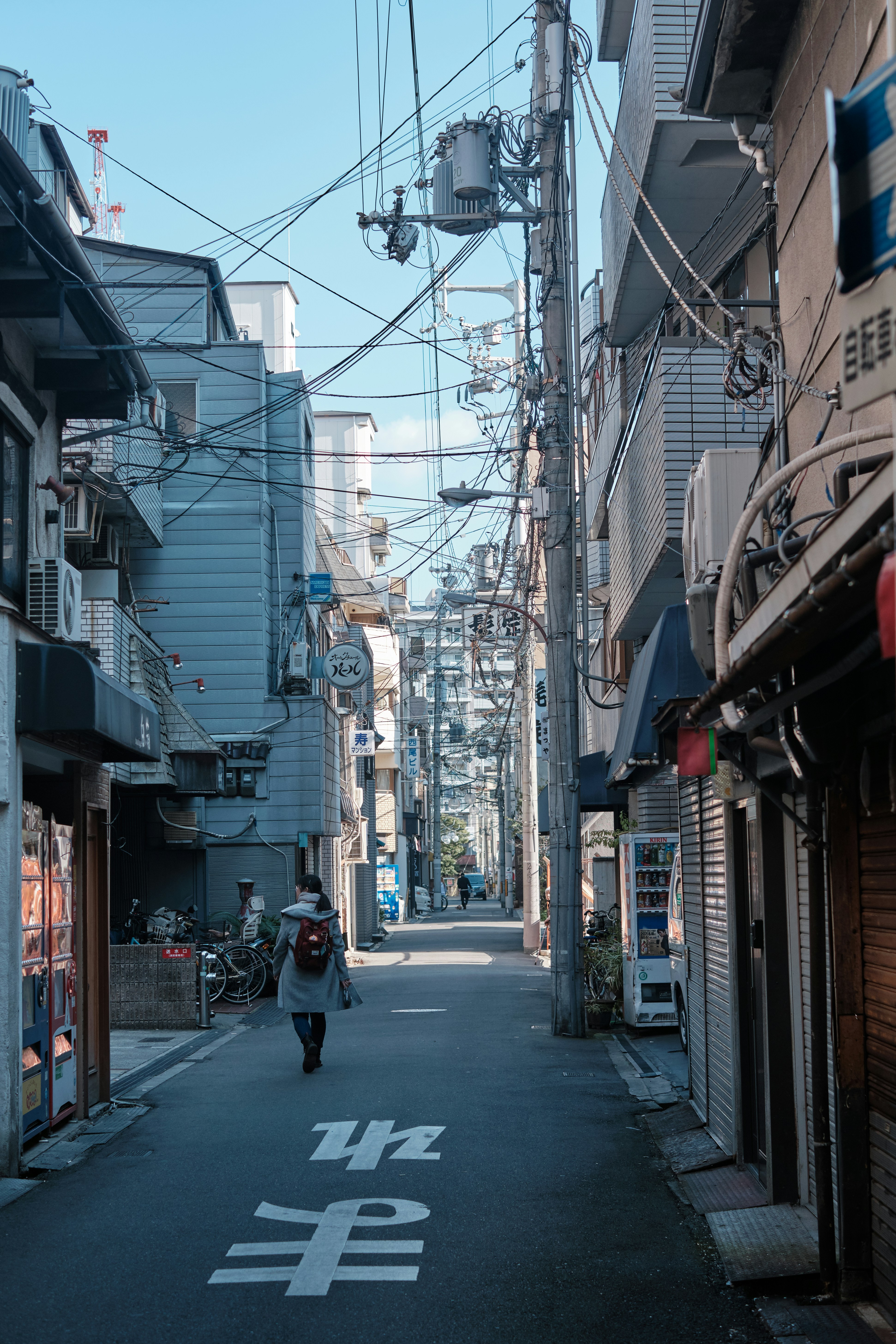 woman walking near houses during daytime