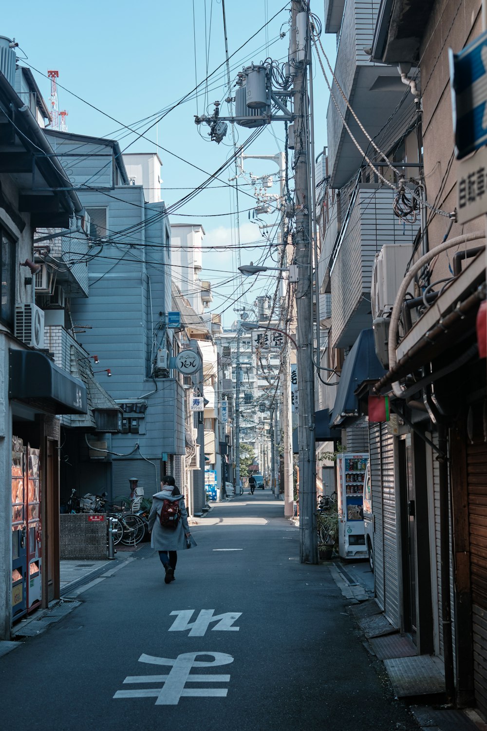 woman walking near houses during daytime