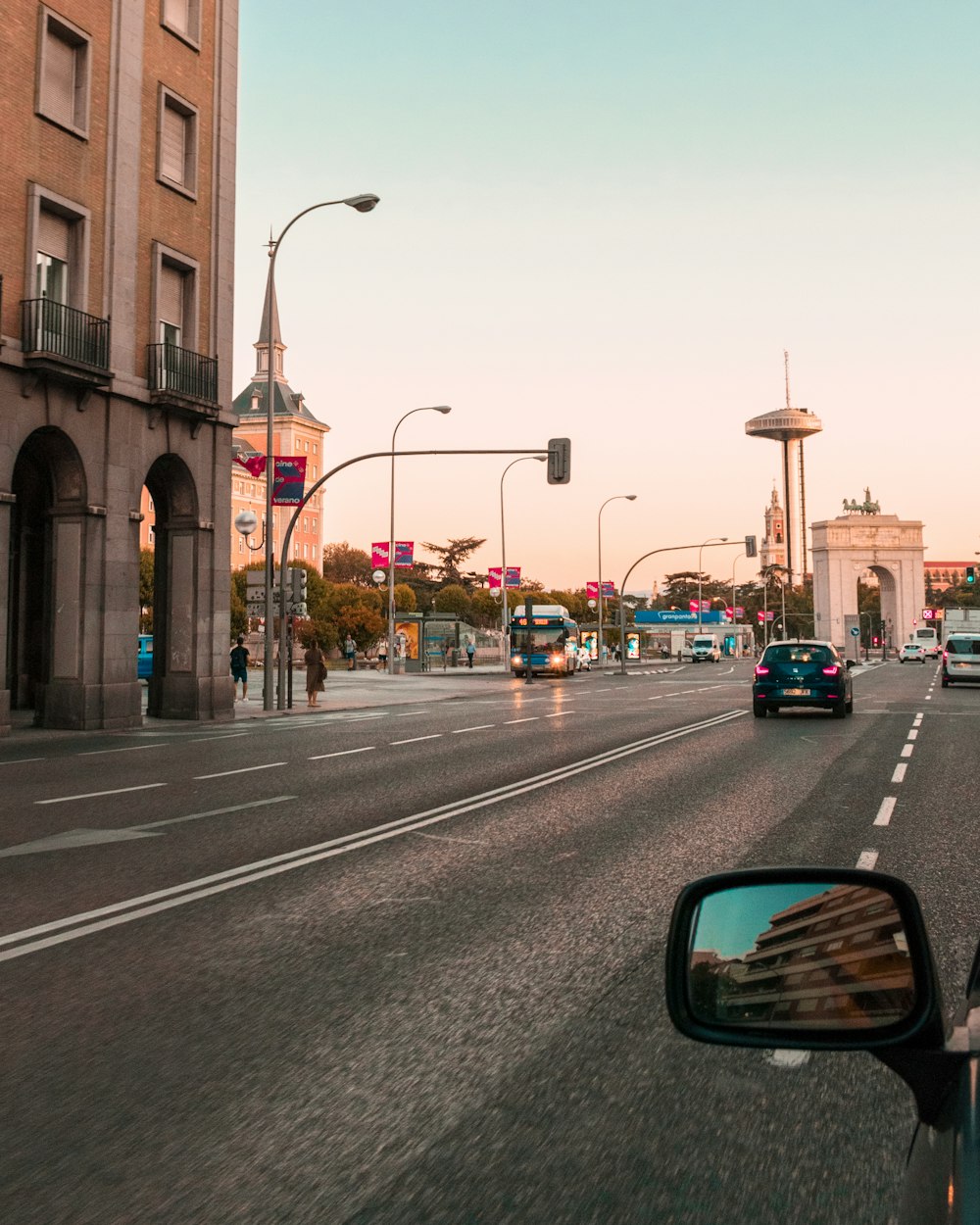 few people walking on street and different vehicles on road during daytime