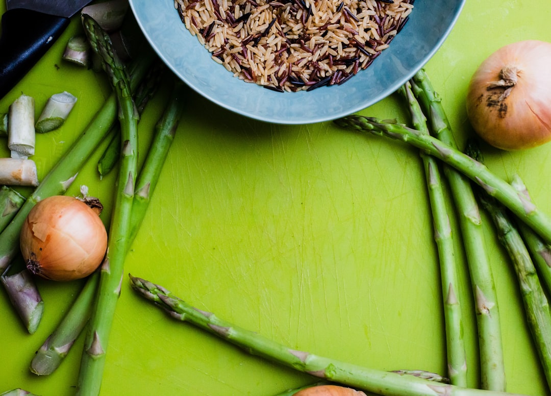 flat-lay photography of green asparagus and white onions