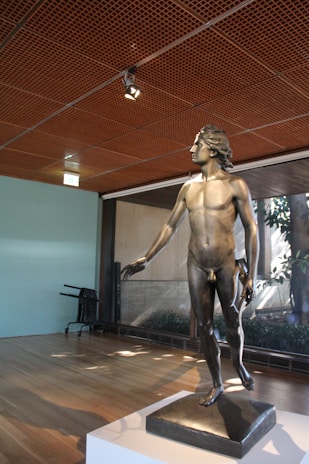 An elegant sculpture displayed in a modern gallery space with soft lighting.