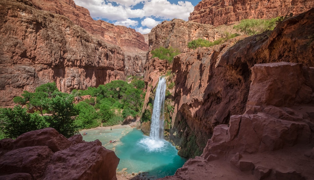 Havasupai Falls in Arizona under white and blue sky