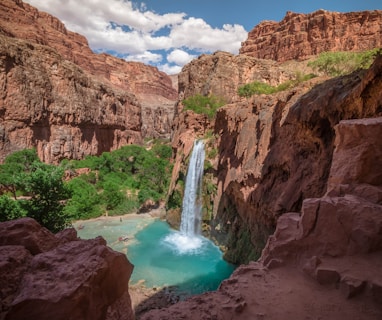 Havasupai Falls in Arizona under white and blue sky