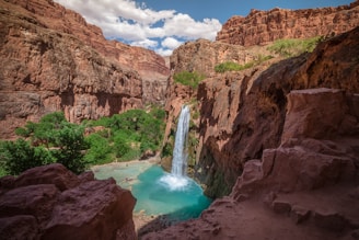 Havasupai Falls in Arizona under white and blue sky