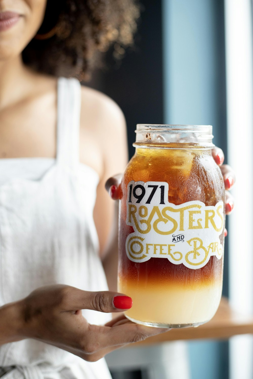 woman holding full 1971 Roaster and Coffee Bar jar