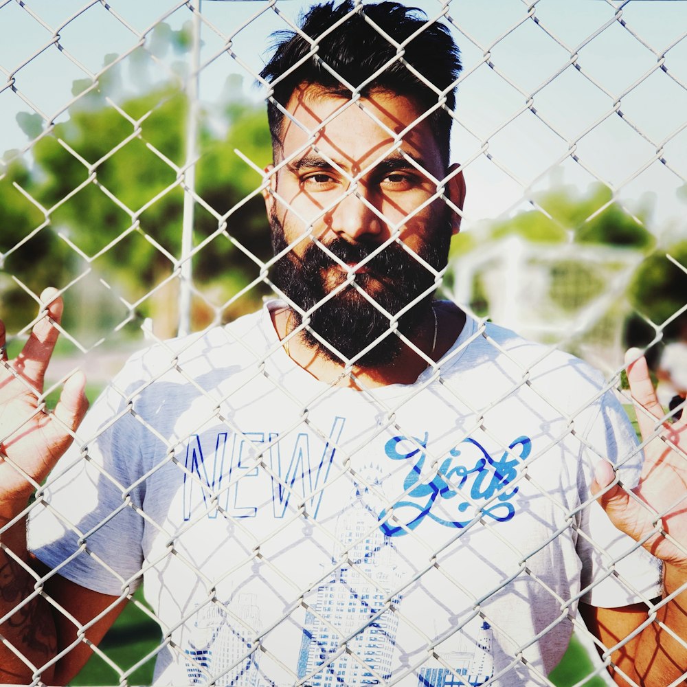 man standing in front of barbwire