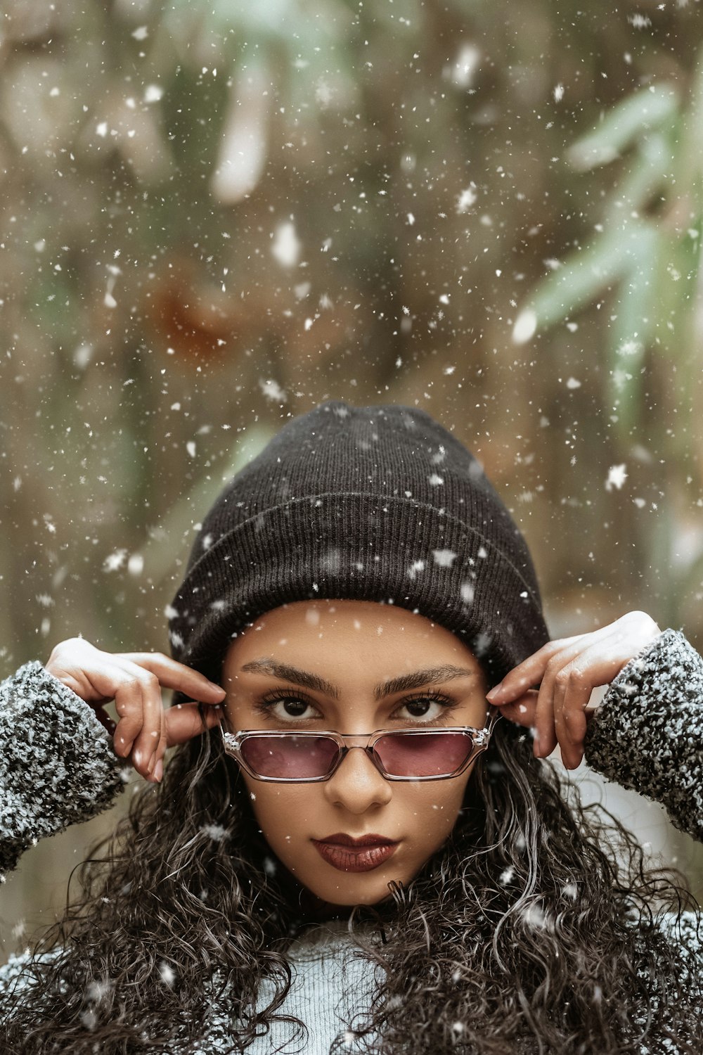 woman holding her sunglasses