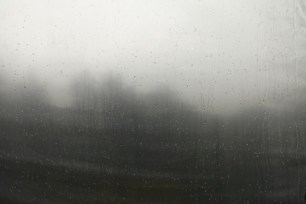 a window with rain drops on the glass