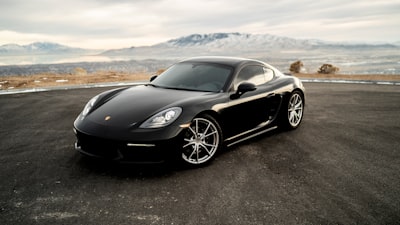 black coupe on road during daytime porsche teams background