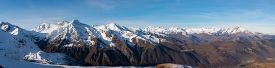 summit view of mountain covered with snow under blue and white sky in Peyresourde France