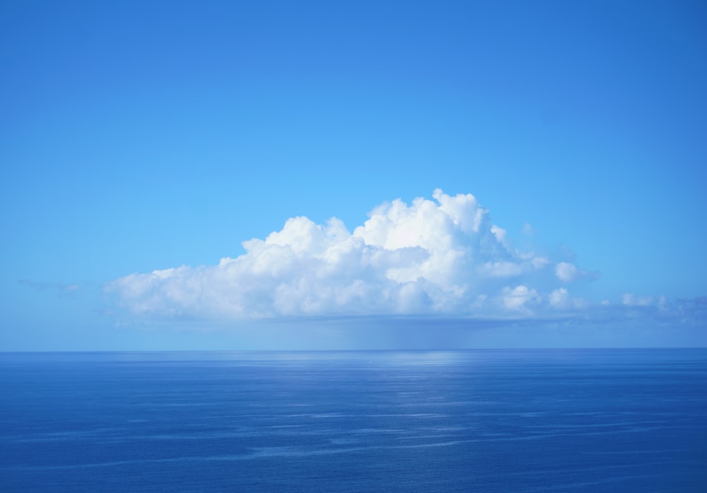 blue body of water under white and blue sky