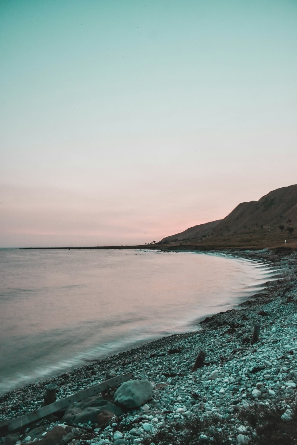 sea near mountain during daytime