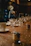 Close-up of a candlelit table setting with elegant glassware and a gold-accented menu.