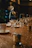 Close-up of a candlelit table setting with elegant glassware and a gold-accented menu.