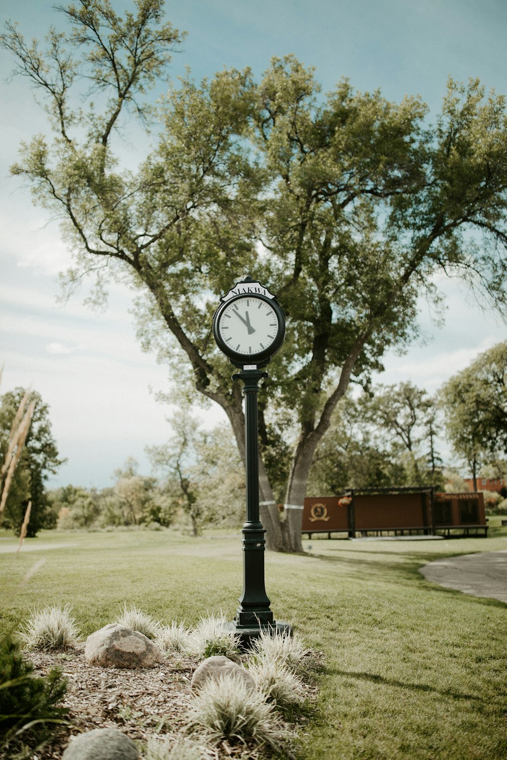 white and black analog pole clock