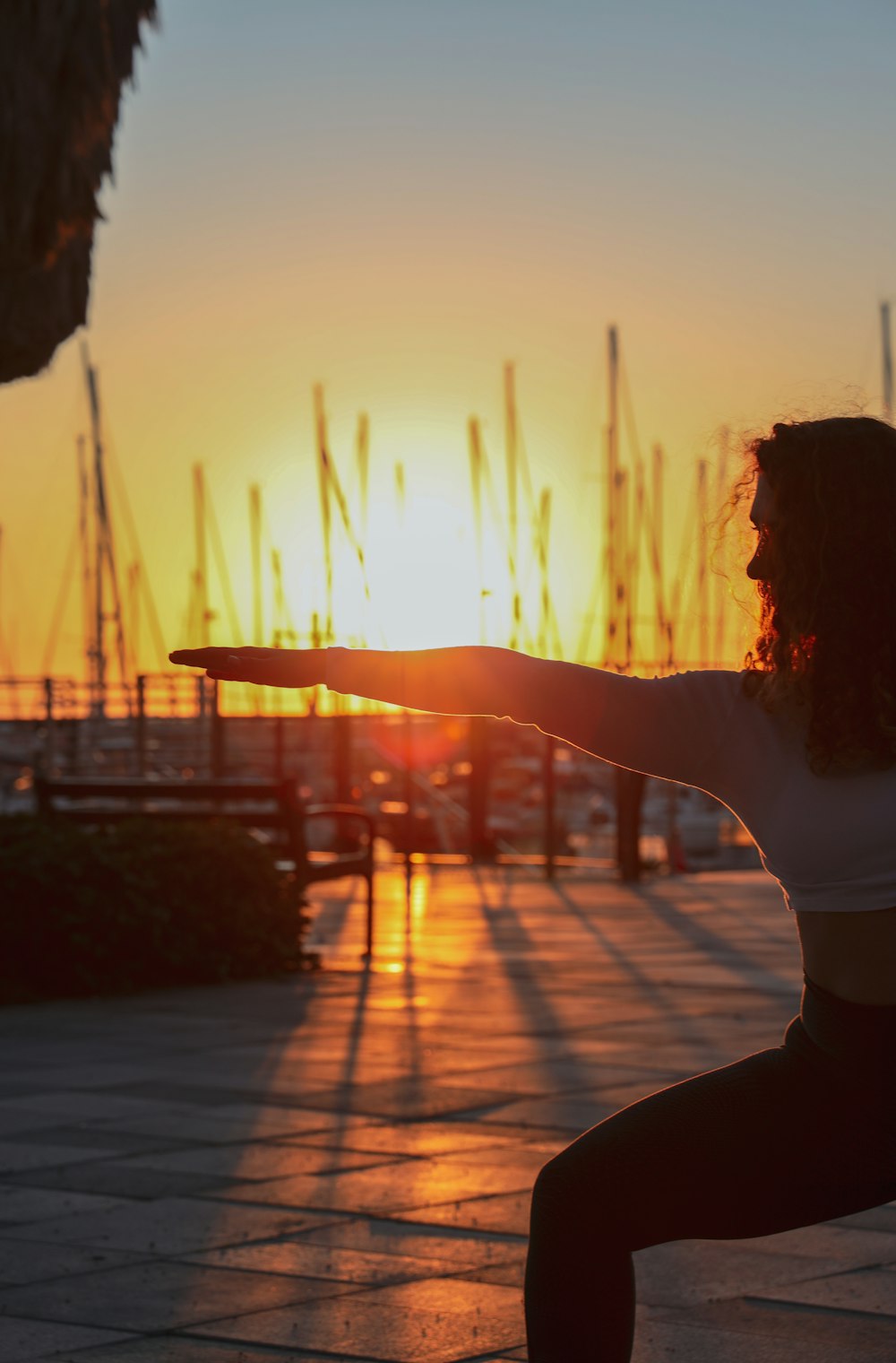 woman standing while doing doing on pathway