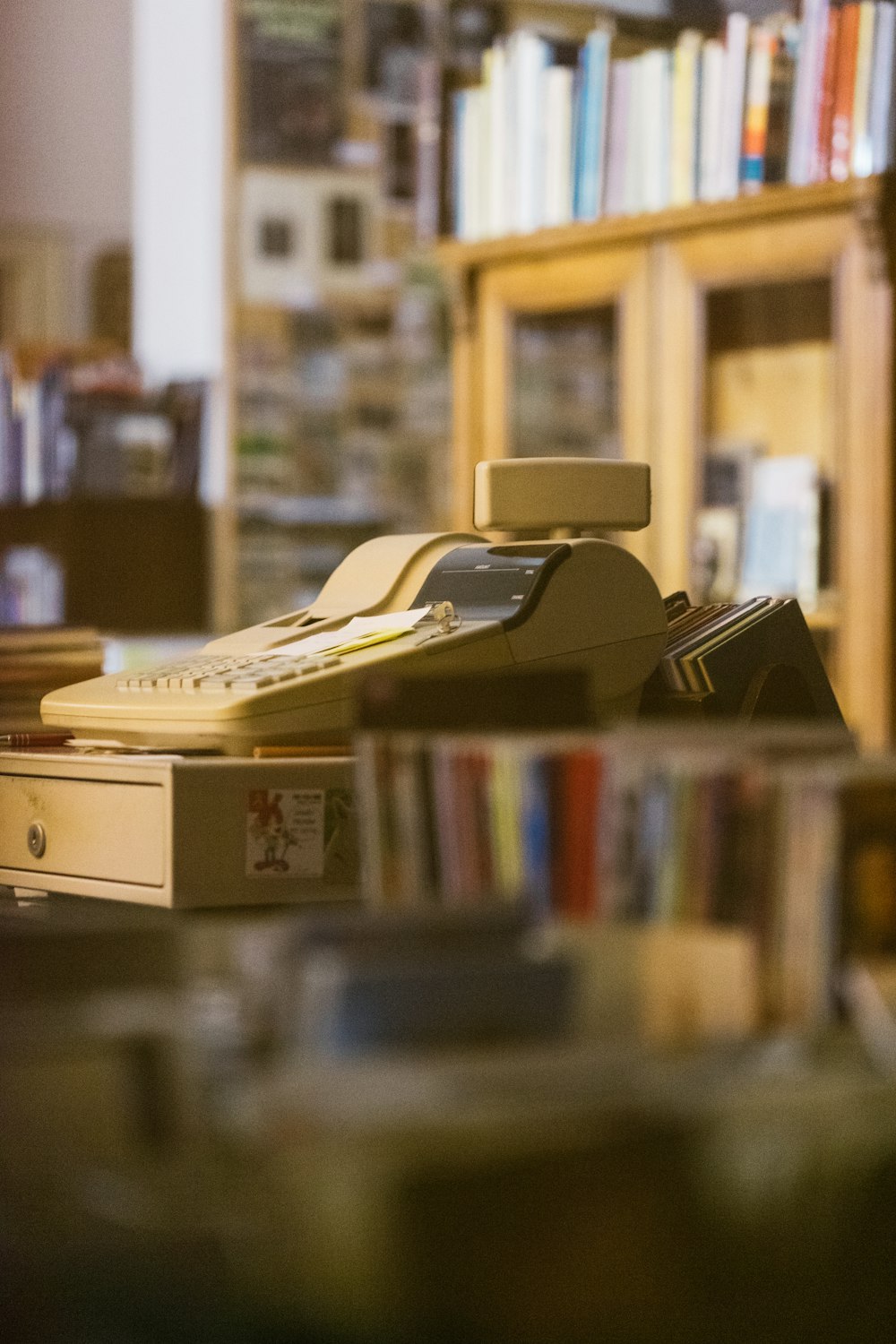 white cash register inside book store