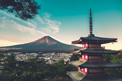 A serene view of Mount Fuji with a cozy shop in the foreground, symbolizing our location.