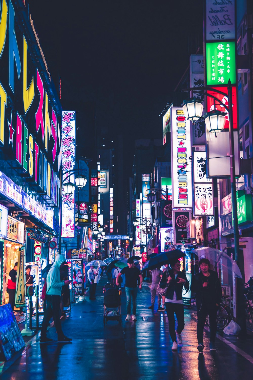 photography of people walking near walkway during nighttime