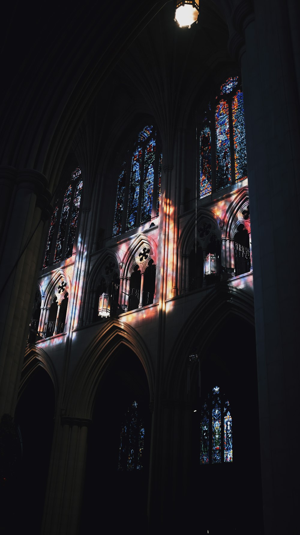 a large cathedral with stained glass windows and a clock