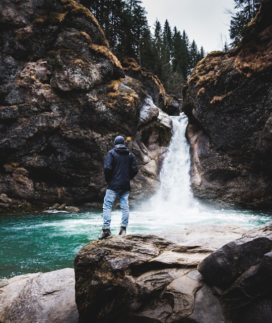 man standing near waterfall in Bavaria Germany