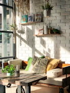 A rustic wooden bench stool placed beside a cozy reading nook with soft cushions.