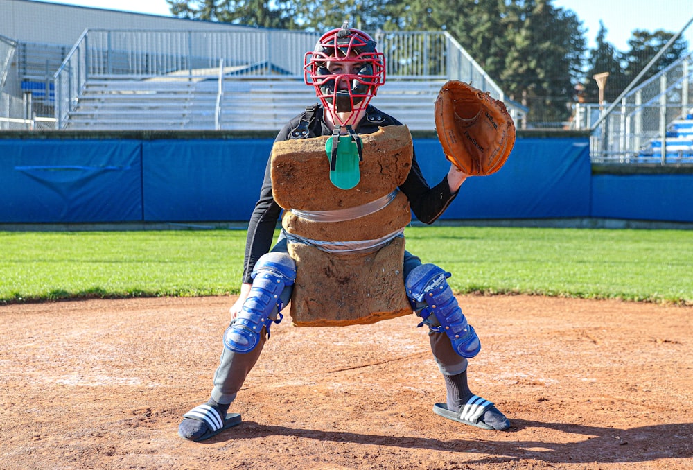 person wearing brown cushion, brown baseball mitt, and helmet