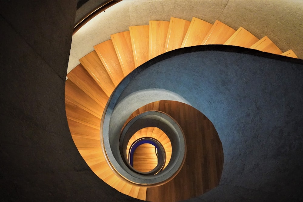 high-angle photo of brown wooden spiral staircase